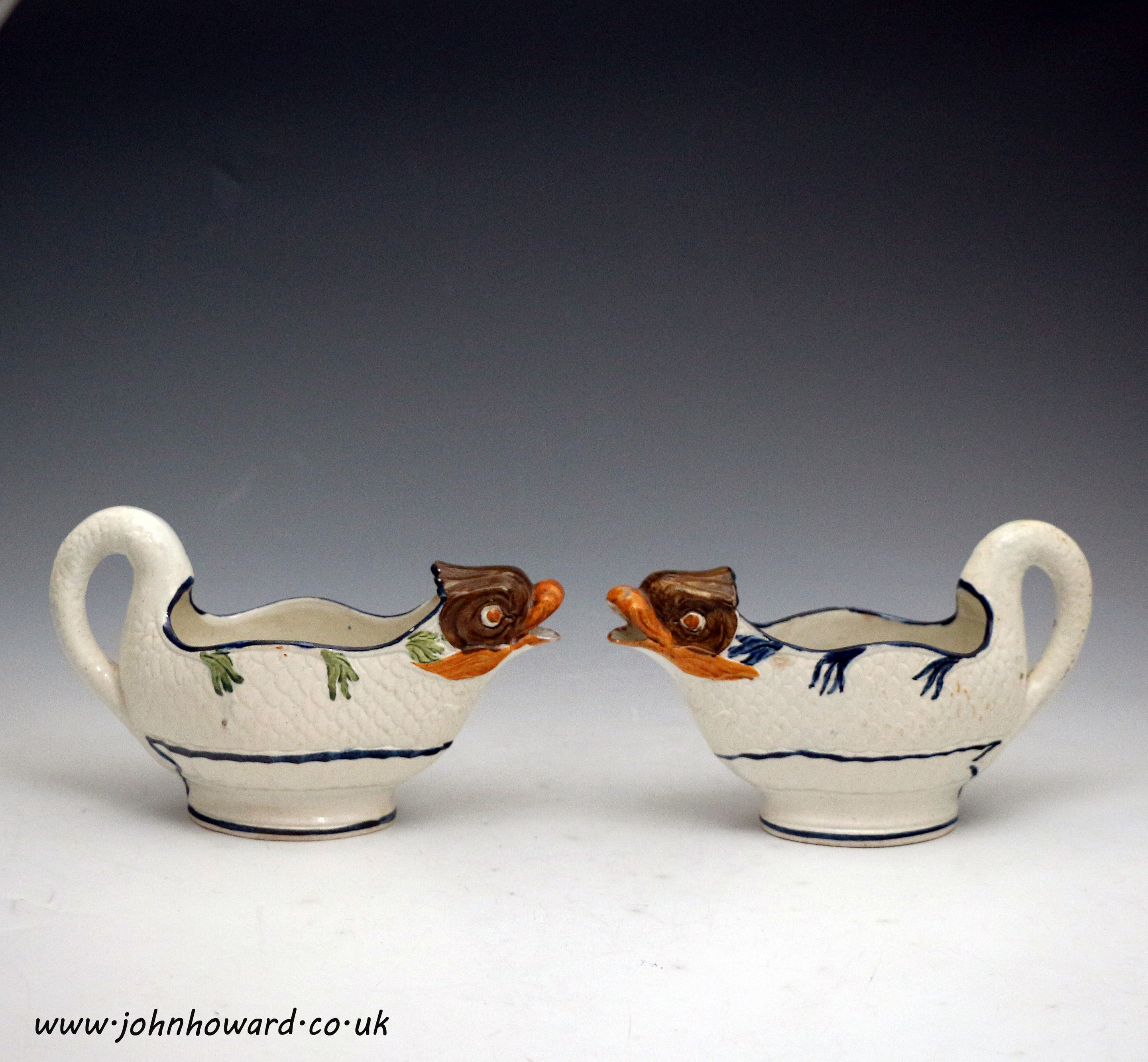 Two English pottery prattware dolphin figure sauce boats. Antique period early 19th century