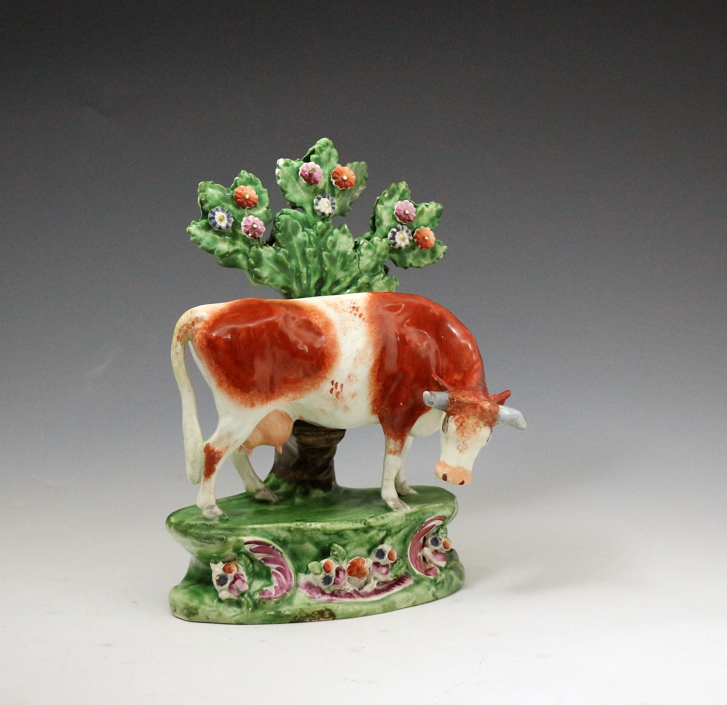 Staffordshire pottery figure of a cow with bocage pearlware figure early 19th century