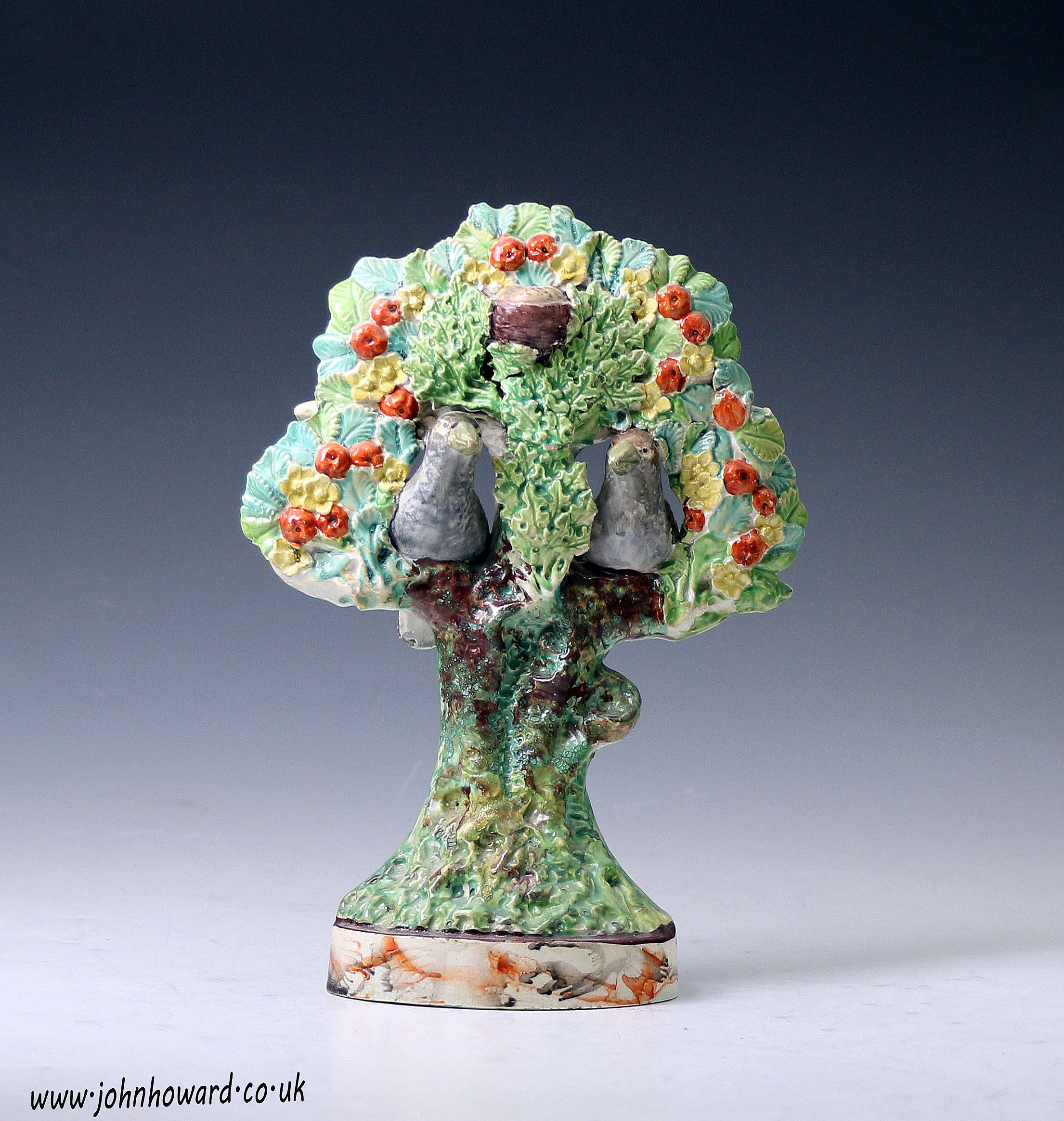 Staffordshire pottery bocage figure with two birds and nest in tree early 19th century English.