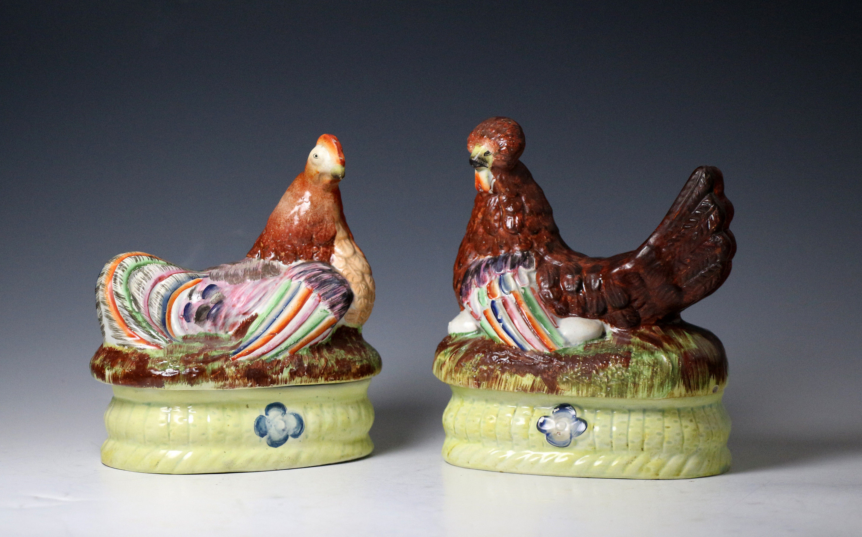 Pair of Staffordshire pottery pearlware  hens seated on baskets.
