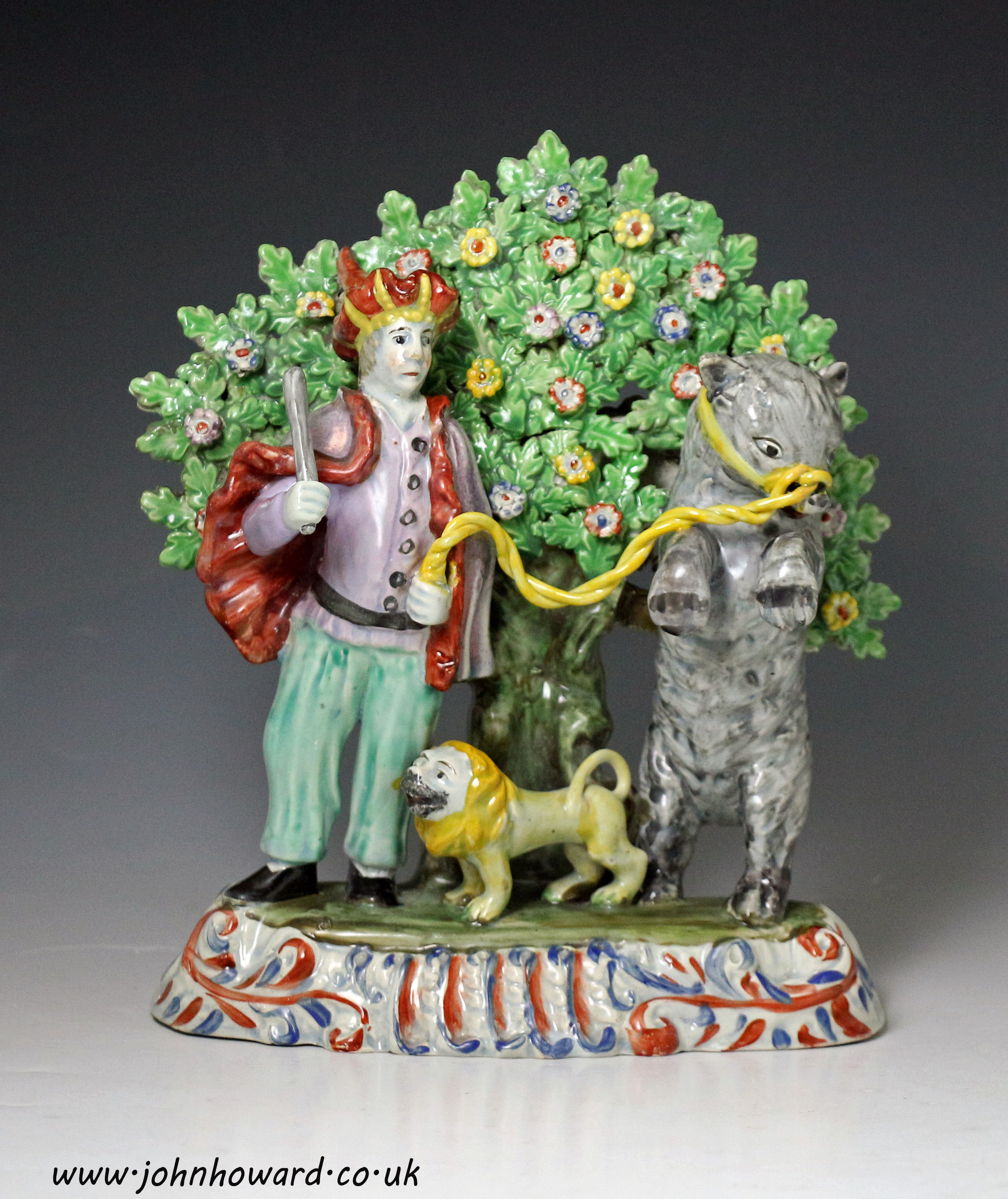 Staffordshire pottery pearlware  bocage figure group of a troubador with lion and bear