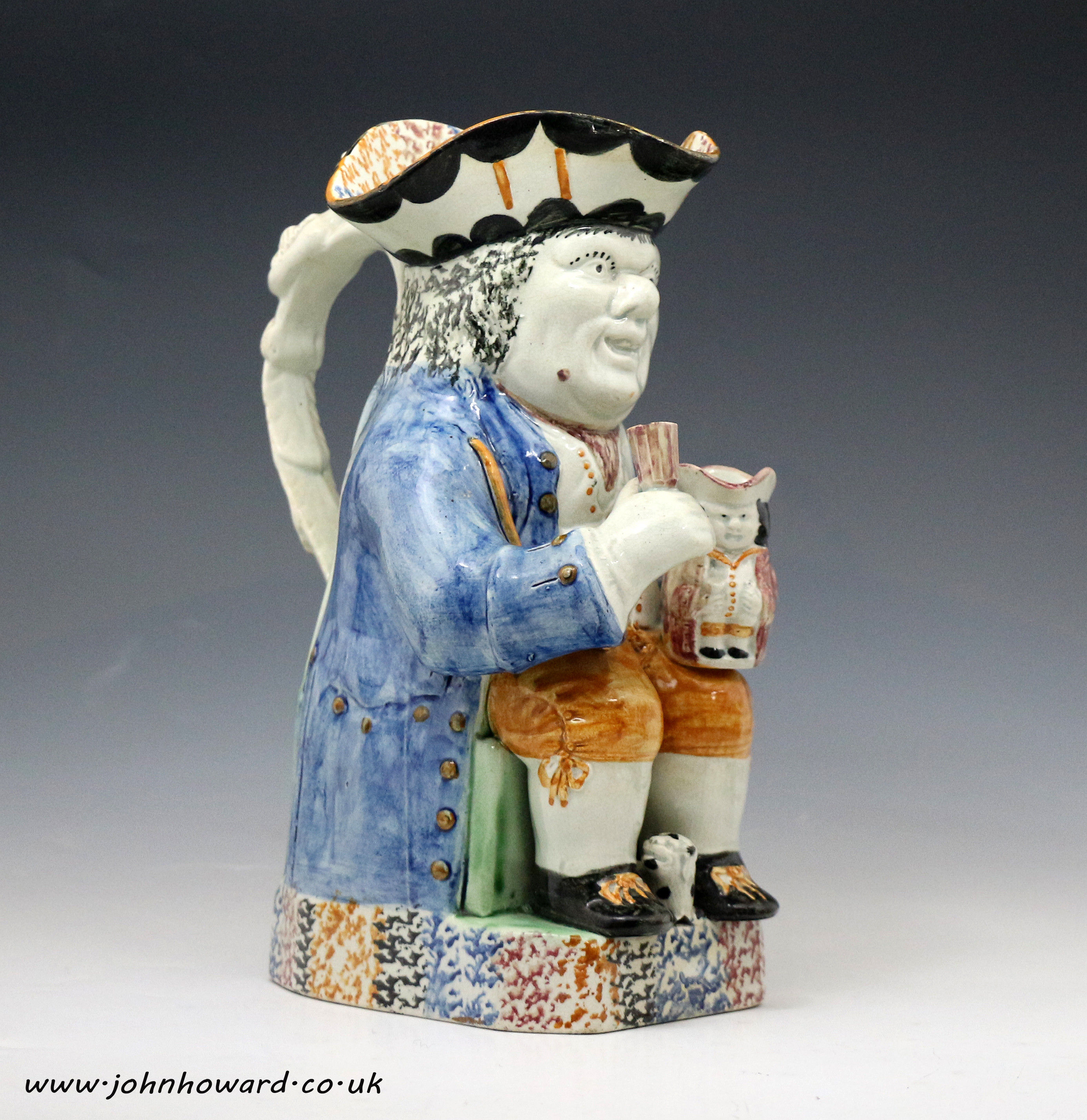 Antique English pottery Pratt-ware Toby jug with figure of dog at base. c1810 period.